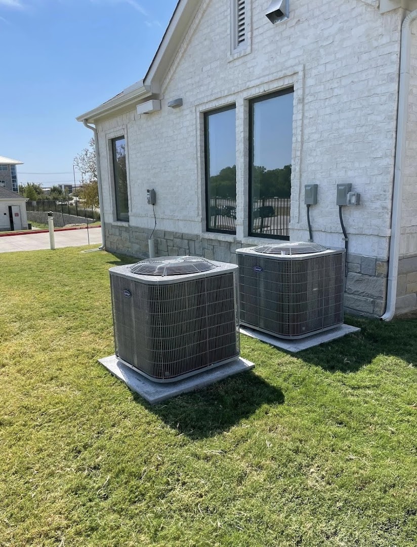 Two newly installed Carrier air conditioning condenser units at a commercial building